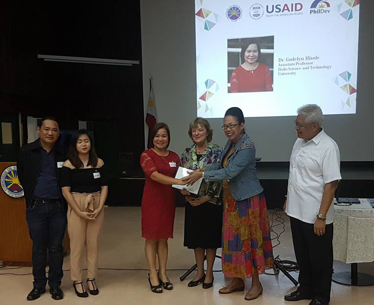 Dr. Hisole recieves the award with Dr. Russ Allen B. Napud (far left) Dean, College of Engineering and Architecture.