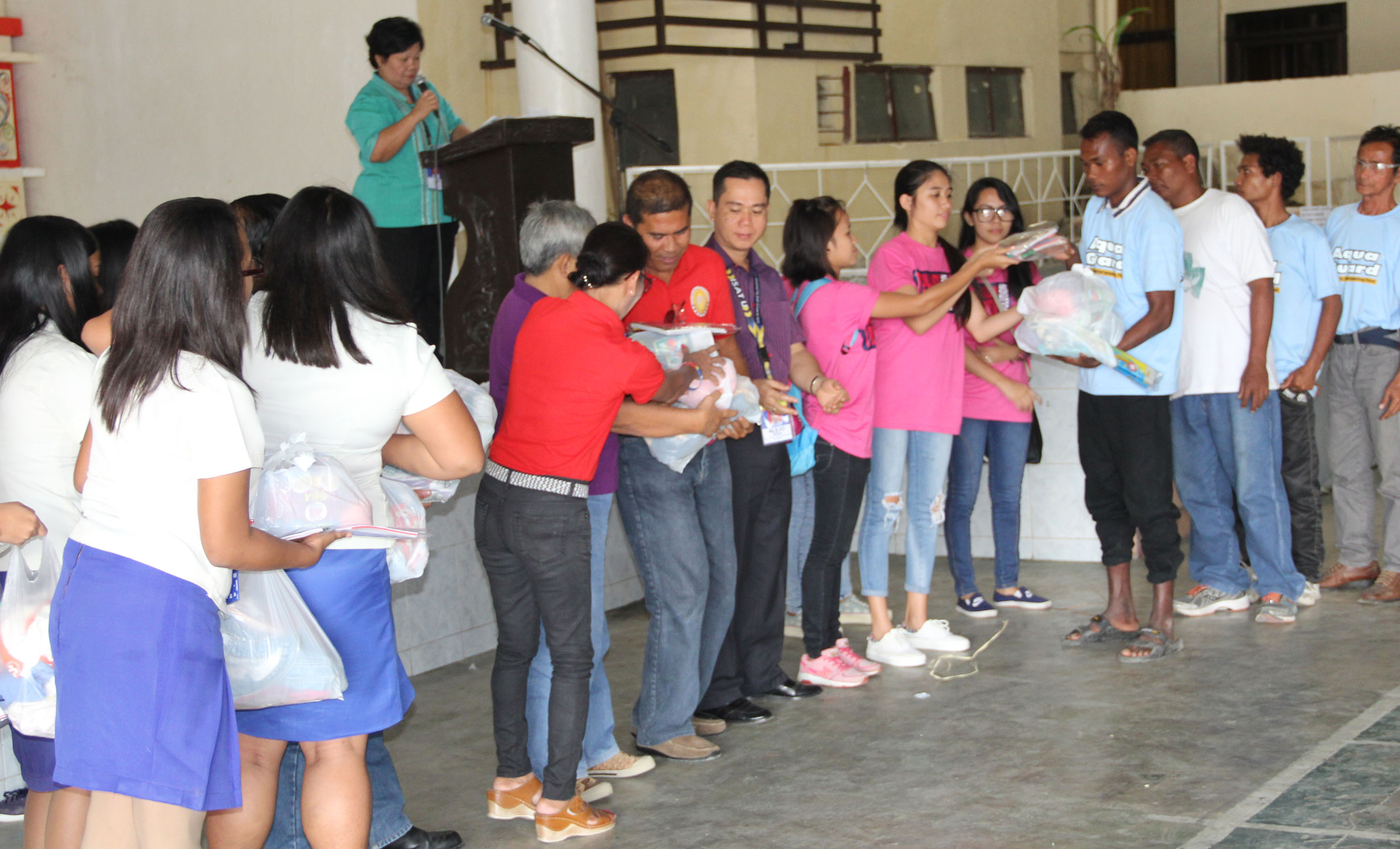 Ati visitors receive goods and grocery items from Literature class students. 