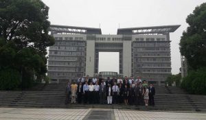 The participants take time to pose with Zhejian Institute of Economics in the background.