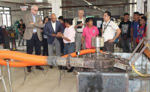 Dr. Wayne Holden and Mr. Paul Weisenfeld listen as Engr. Salvador Senorio explains how the S-Turbine Water Pump works.